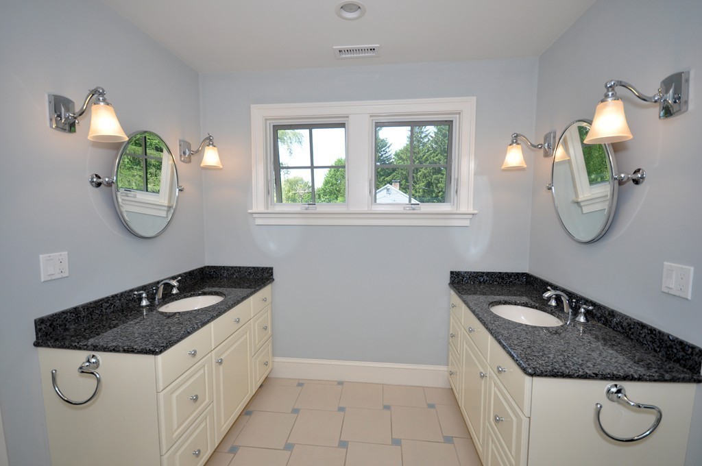 1643 Monument Street Concord, MA 01742 - Photo 23 of 27 a bathroom with a granite countertop sink and a mirror