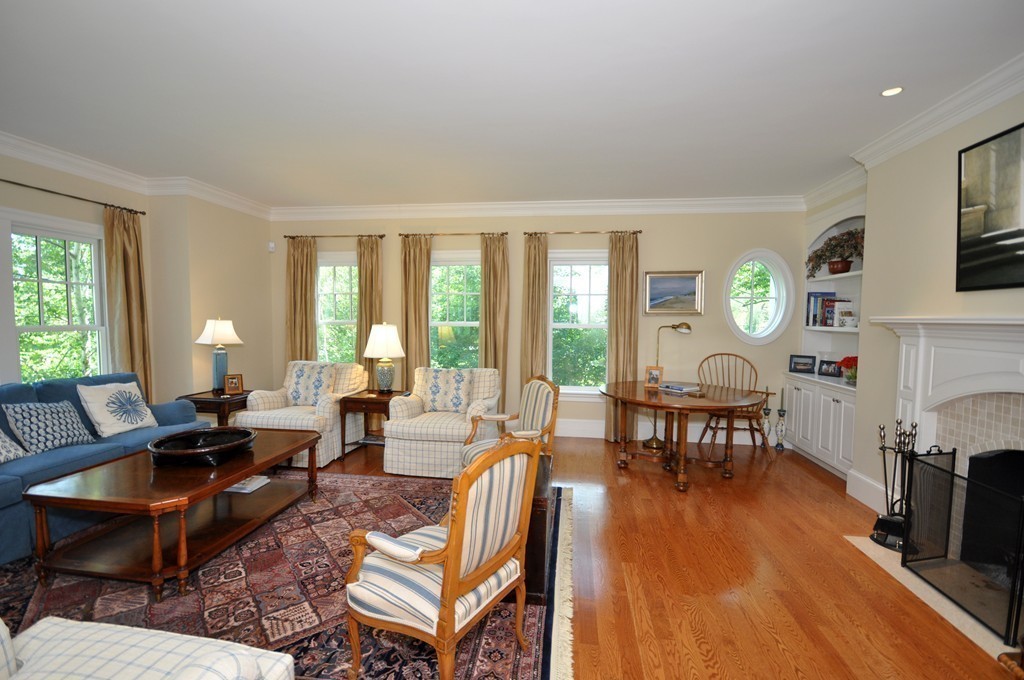 1643 Monument Street Concord, MA 01742 - Photo 5 of 27 a living room with fireplace furniture and a wooden floor