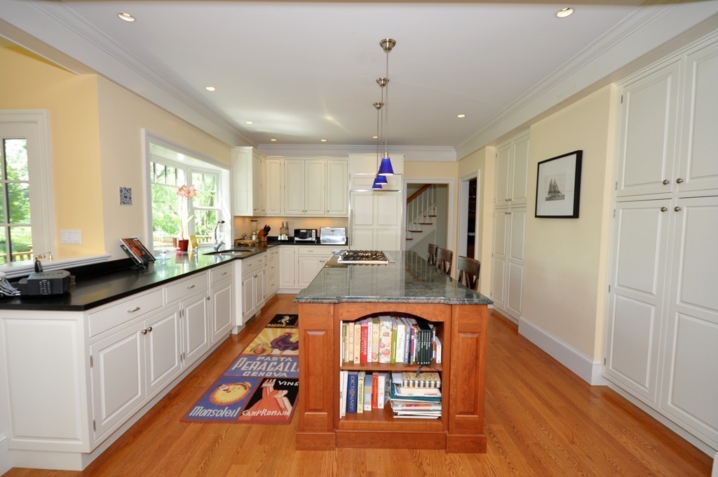 1643 Monument Street Concord, MA 01742 - Photo 7 of 27 a very nice looking kitchen with granite countertop a large window and stainless steel appliances