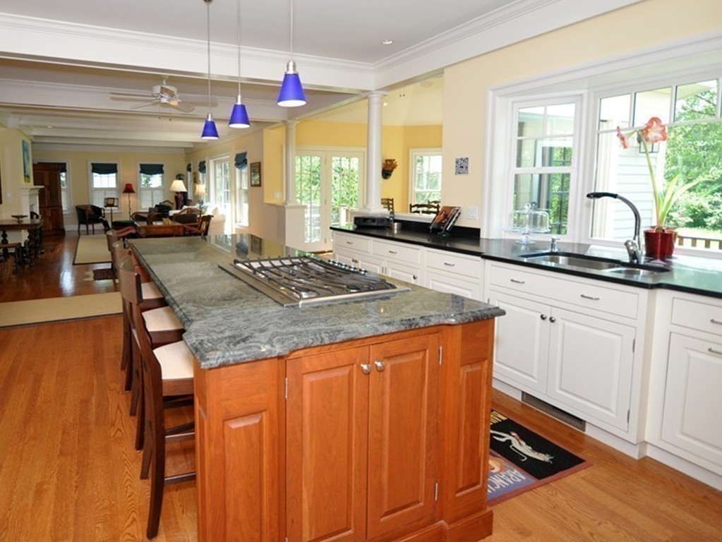 1643 Monument Street Concord, MA 01742 - Photo 10 of 27 a kitchen with granite countertop sink and cabinets