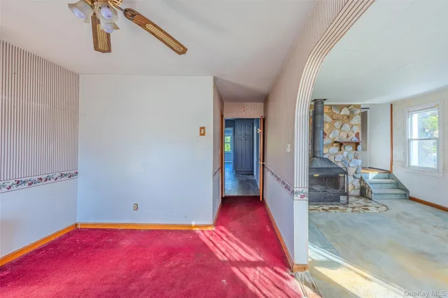 a view of a room with window and hardwood floor