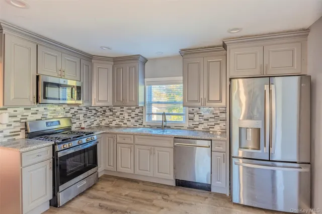 a kitchen with stainless steel appliances a refrigerator stove and sink