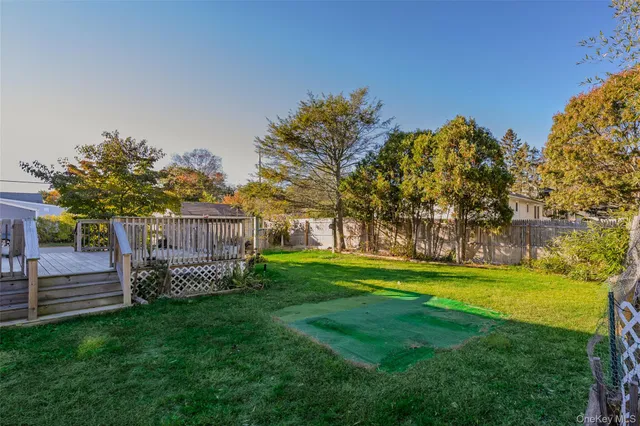 a view of a backyard with wooden fence