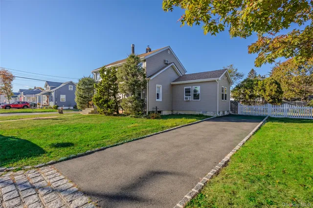 a front view of a house with a garden and yard