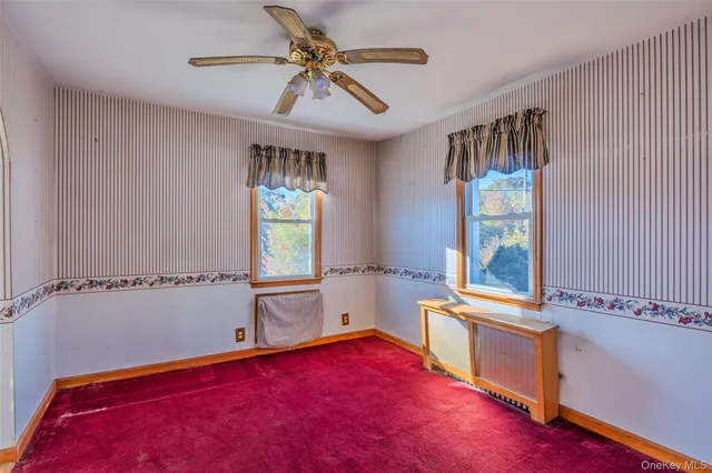 a view of a room with window and a ceiling fan
