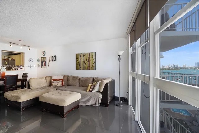 a living room with furniture a rug and a wall painting