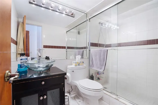 a bathroom with a sink toilet and shower