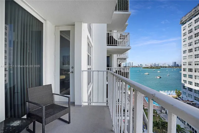 a view of a balcony with chair and iron gate