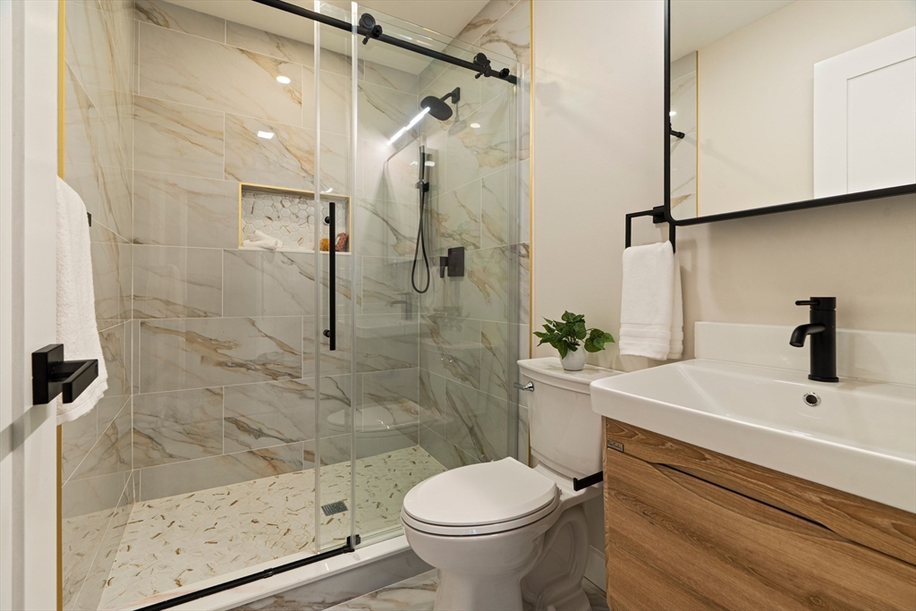16 Yale Terrace, Unit 2 Boston, MA 02130 - Photo 21 of 32 a bathroom with a sink a toilet and shower