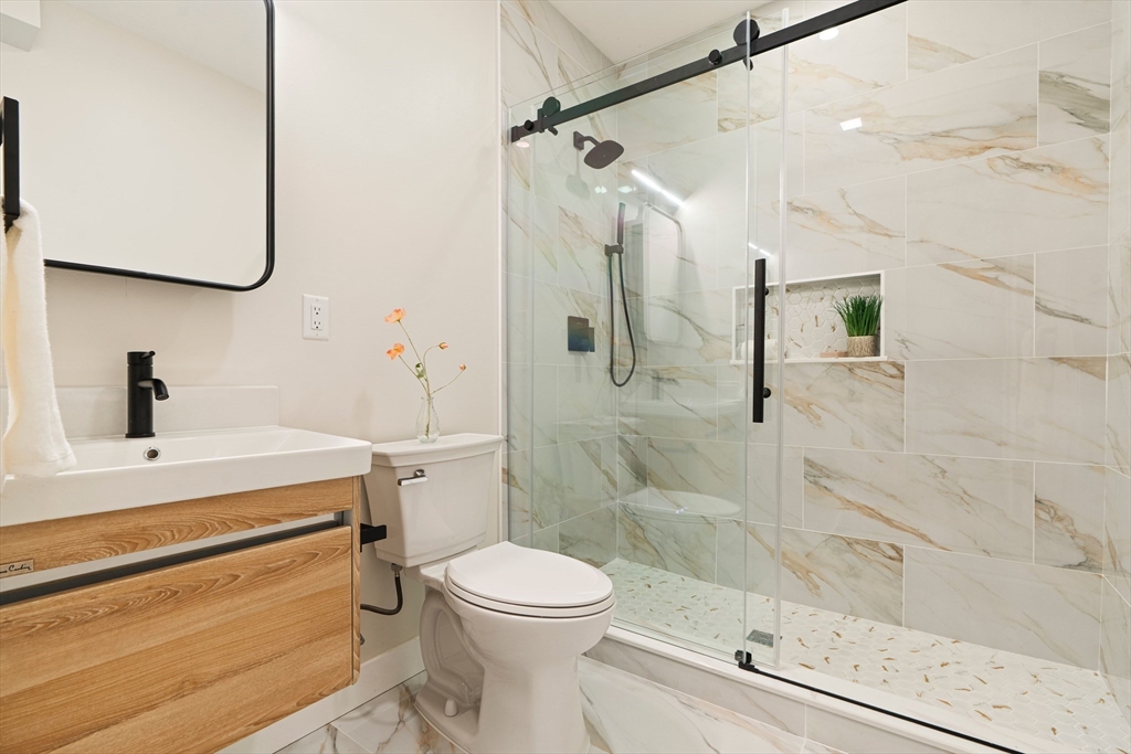 16 Yale Terrace, Unit 2 Boston, MA 02130 - Photo 30 of 32 a bathroom with a sink a toilet and shower