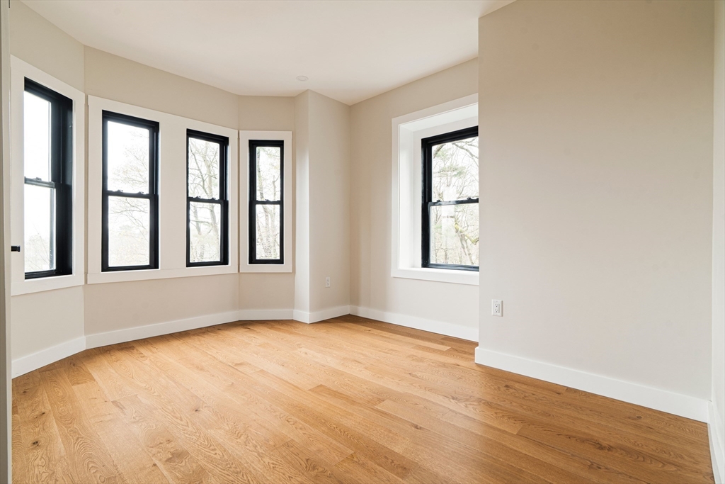 16 Yale Terrace, Unit 2 Boston, MA 02130 - Photo 32 of 32 a view of an empty room with wooden floor and a window