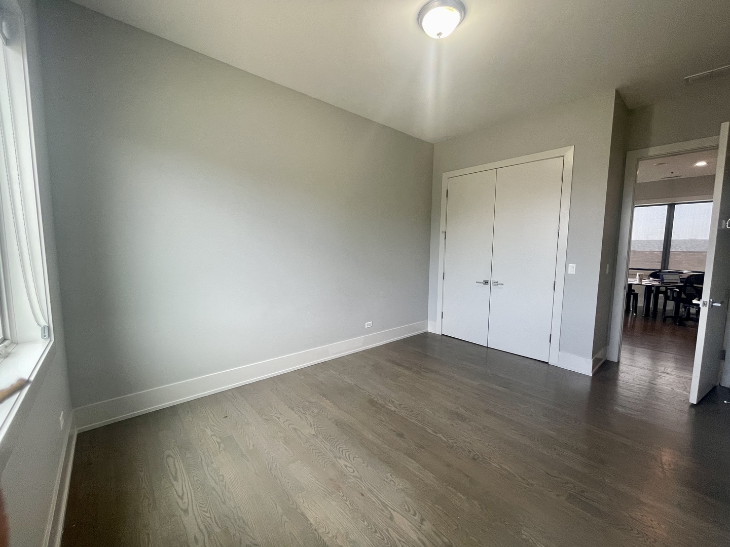 4042 North Pulaski Road, Unit 3E Chicago, IL 60641 - Photo 8 of 23 an empty room with wooden floor and a window