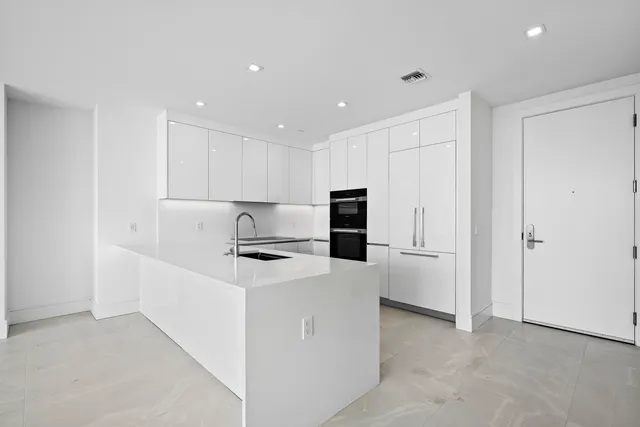 a kitchen with cabinets and stainless steel appliances
