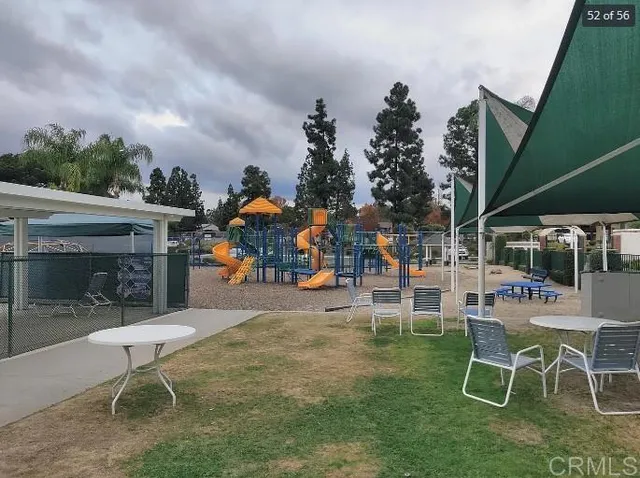 a childrens park with lots of swings and slides