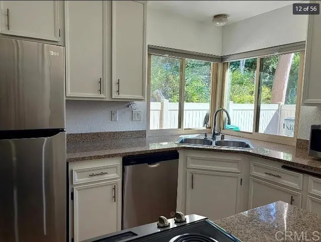 a kitchen with granite countertop a sink and a window