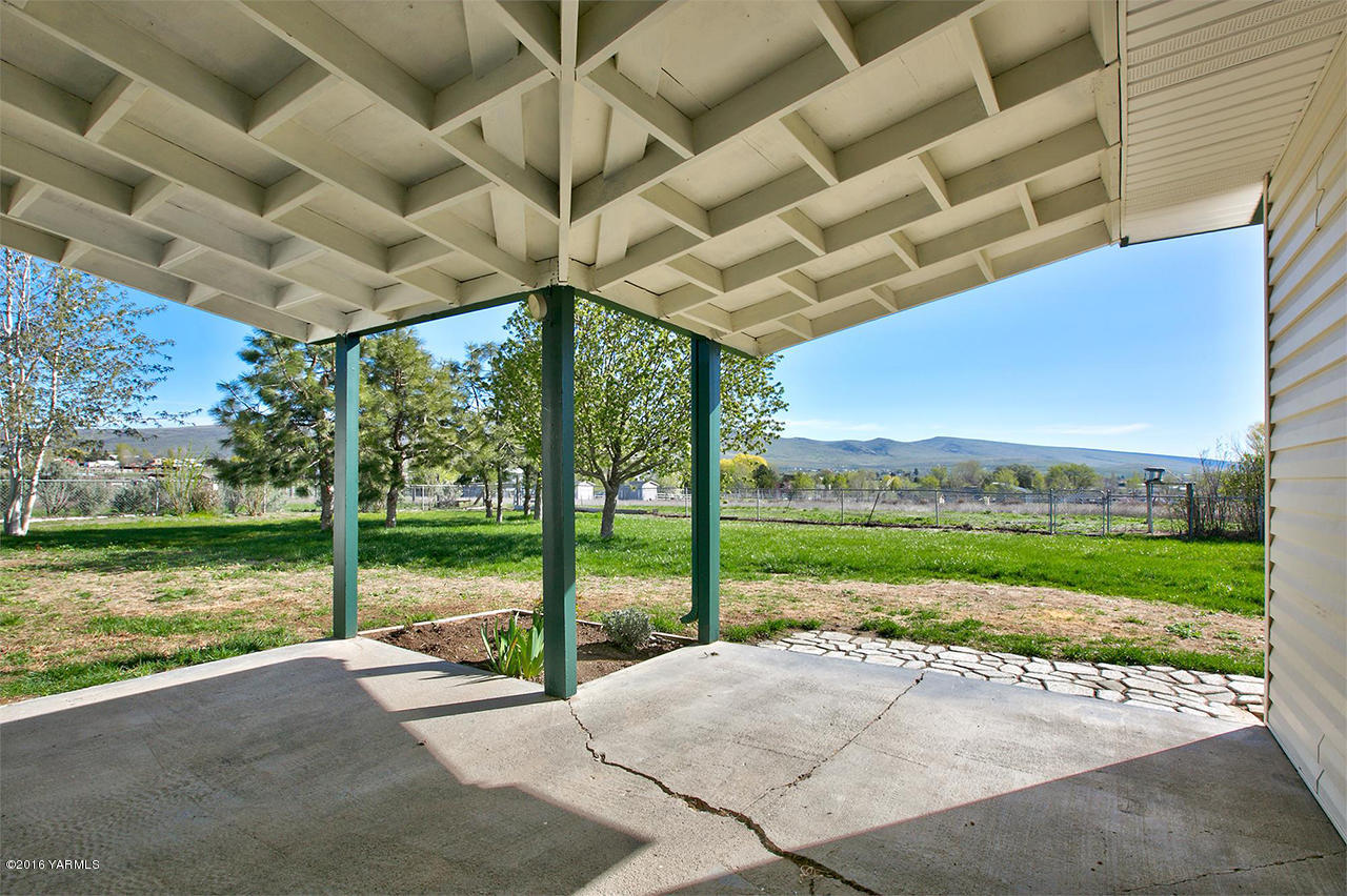 71 Sheep Company Road Selah, WA 98942 - Photo 13 of 19 a view of a patio with a table and chairs under an umbrella