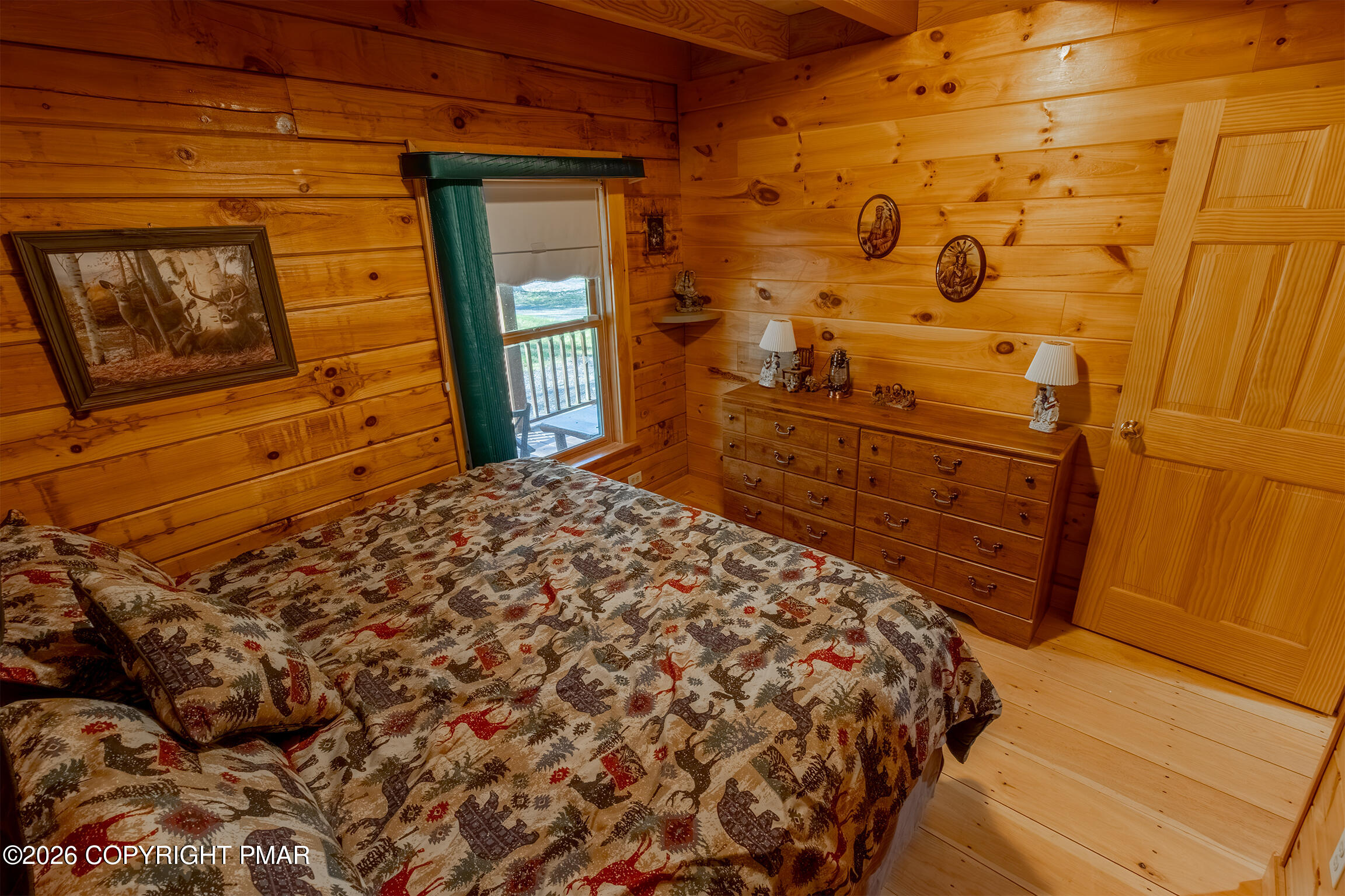 1160 Bluebird Lane Bushkill, PA 18324 - Photo 25 of 44 a bed sitting in a bedroom next to a wooden door