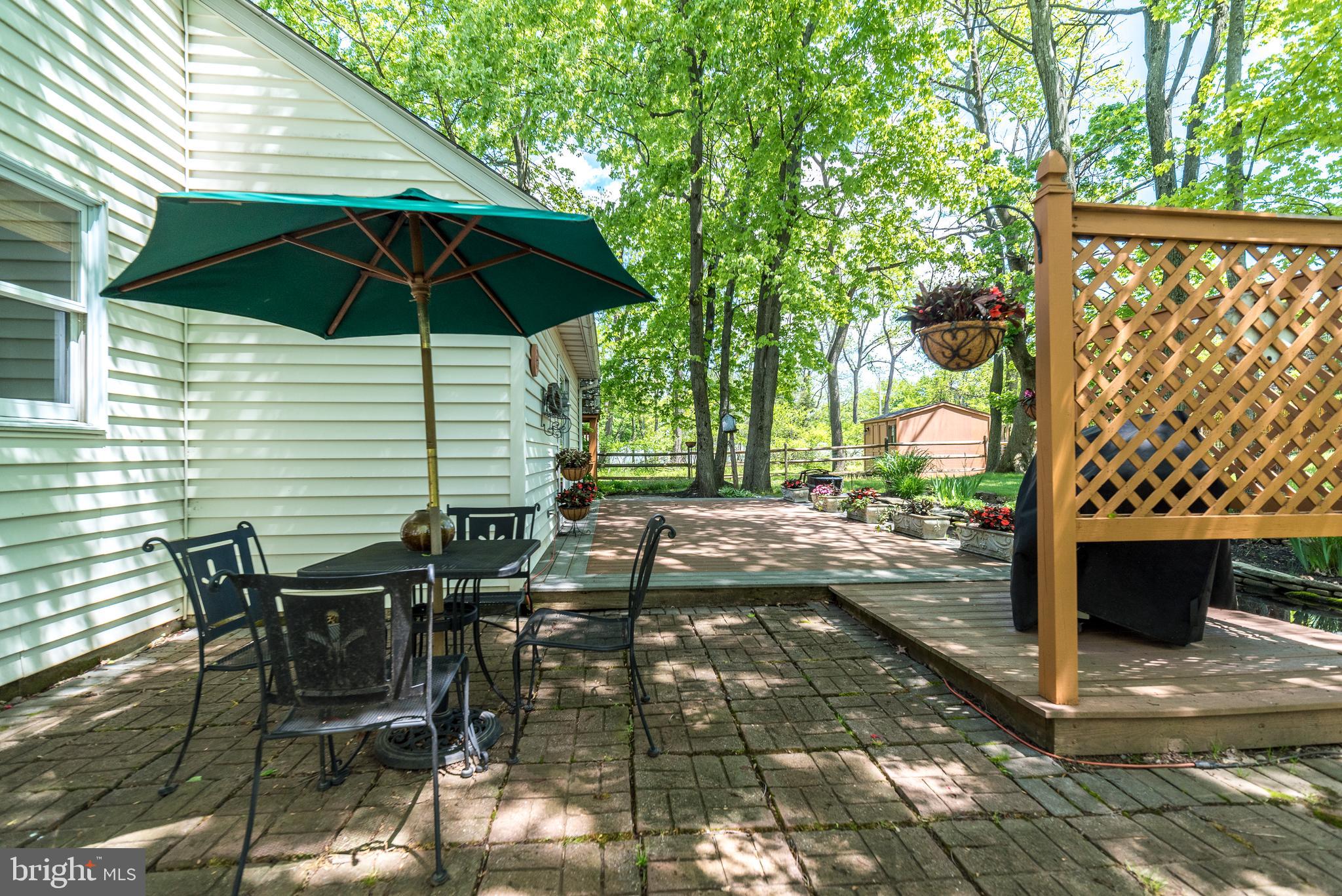 227 Knapp Road Lansdale, PA 19446 - Photo 37 of 41 Paver patio abuts deck