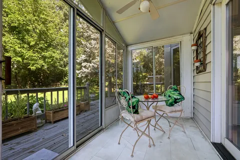 a view of a porch with furniture and garden
