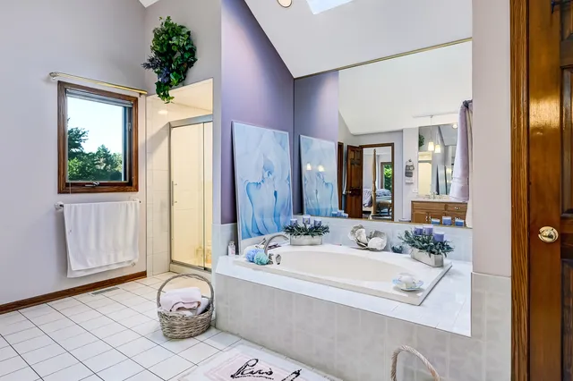 a bathroom with a tub sink and mirror