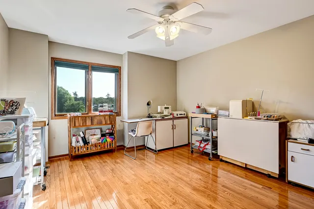 a view of workspace with wooden floor and windows