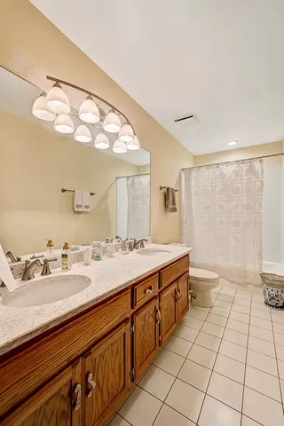 a bathroom with a double vanity sink and a mirror