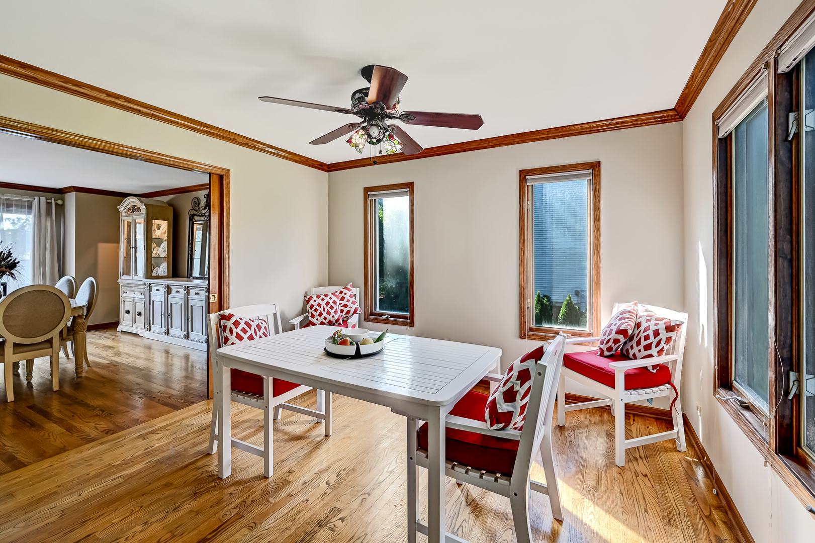 8826 Carlisle Court Darien, IL 60561 - Photo 7 of 36 a dining room with furniture a chandelier and wooden floor