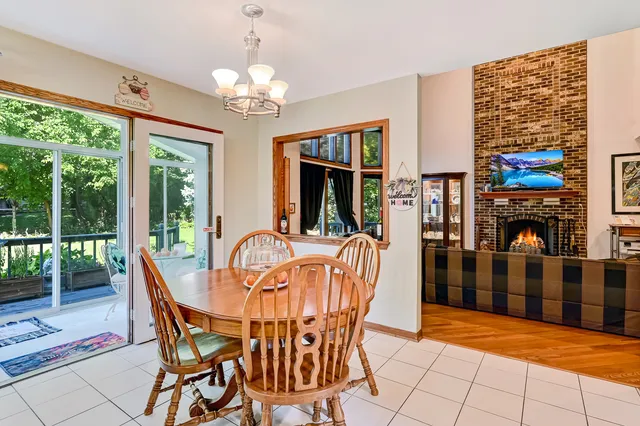 a dining room with furniture a chandelier and window