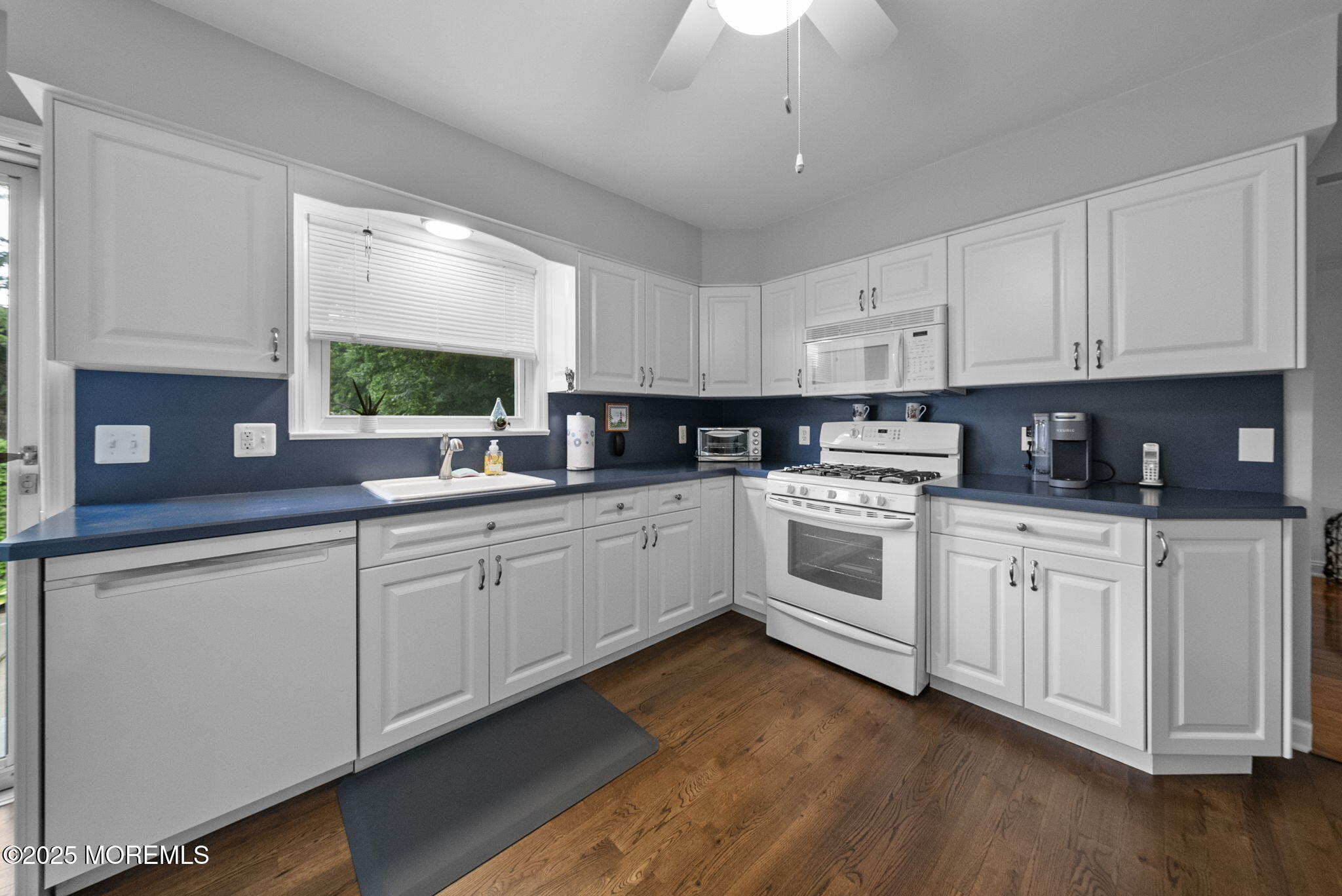 72 Broadway Road Freehold, NJ 07728 - Photo 15 of 37 a kitchen with white cabinets stainless steel appliances a sink and a window
