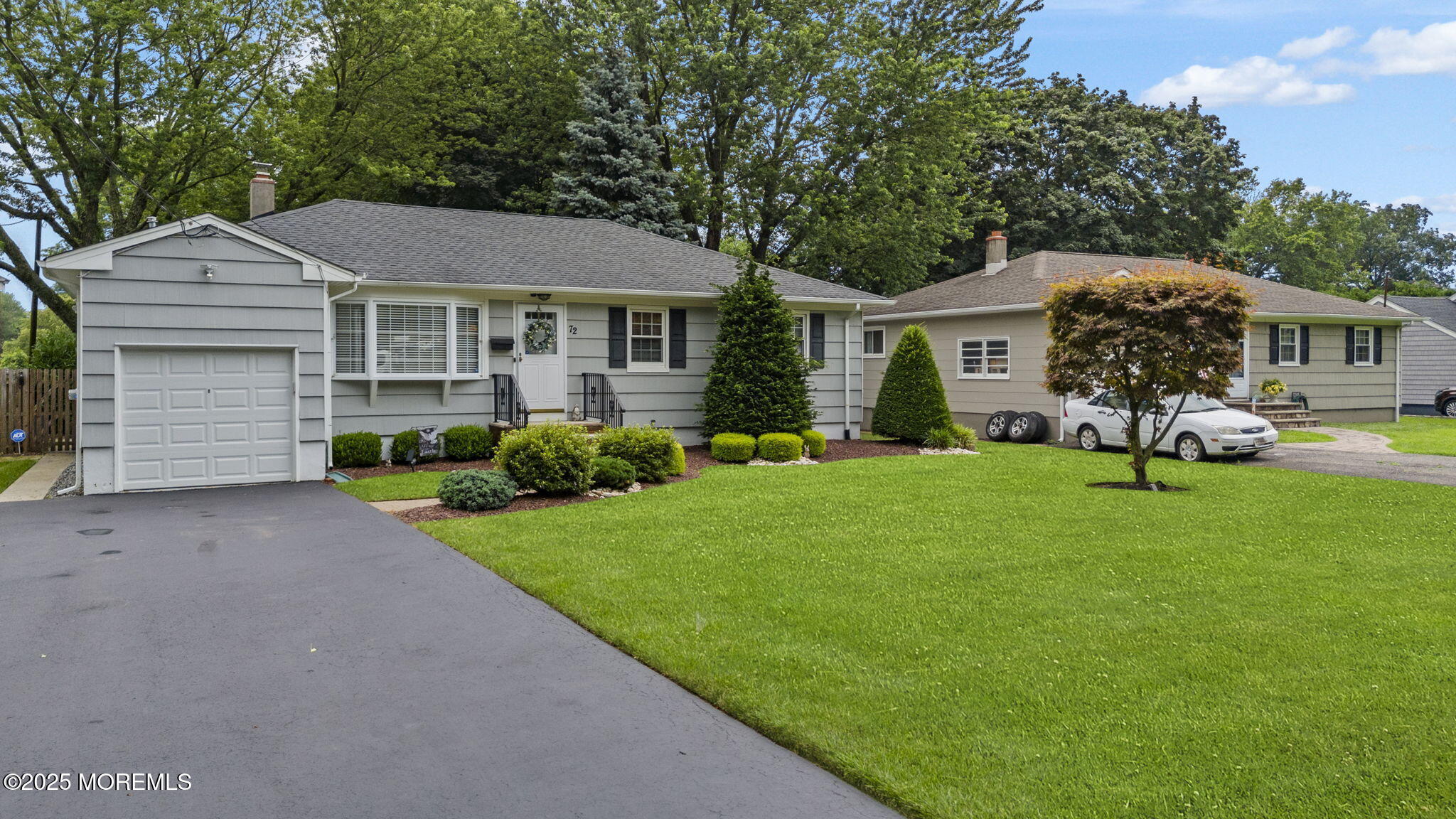 72 Broadway Road Freehold, NJ 07728 - Photo 2 of 37 a front view of a house with a garden and porch