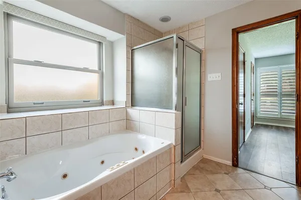 a bathroom with a bathtub and a shower