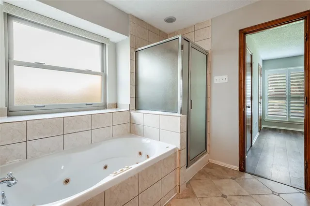 a bathroom with a bathtub and a shower