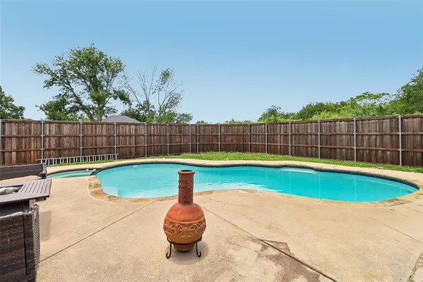 a view of a backyard with swimming pool