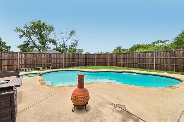 a view of a backyard with swimming pool