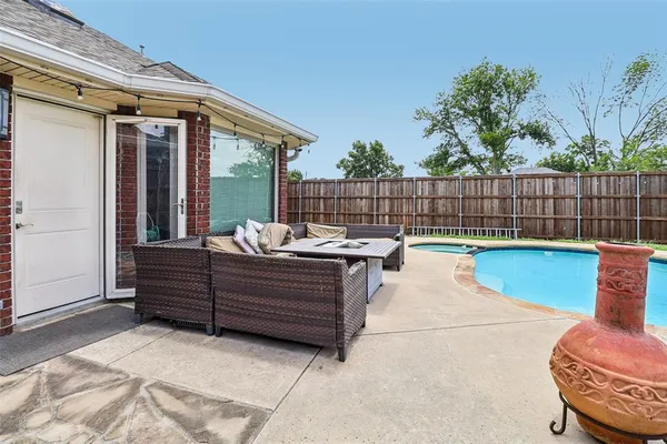 a view of a chairs and tables in the back yard of the house