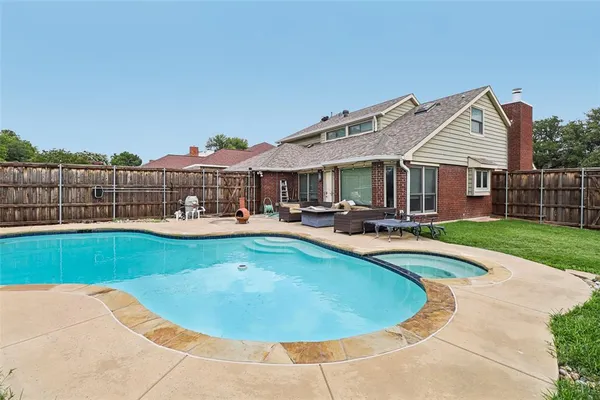 a view of a house with swimming pool and porch