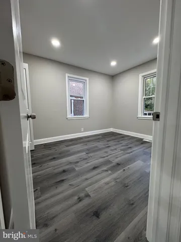 a view of hallway with stairs and wooden floor