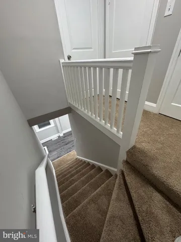 a bathroom with a toilet a sink and a mirror