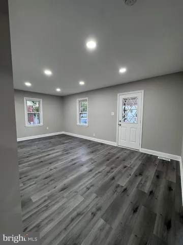 a kitchen with stainless steel appliances a sink cabinets and wooden floor