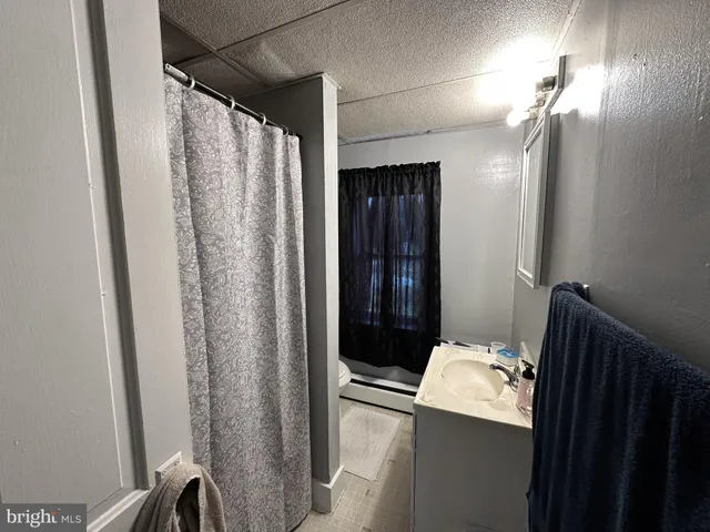 a living room with furniture a large window and gym equipment