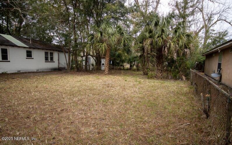 a view of a house with a large tree