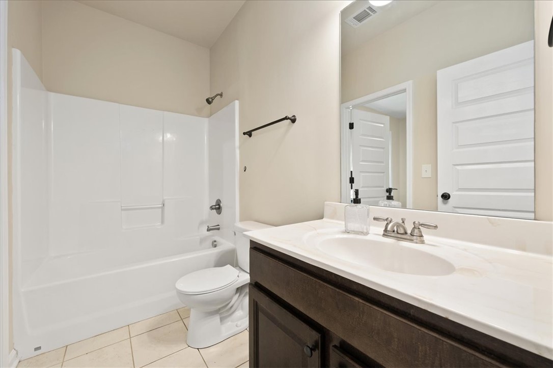 153 Border Avenue Simpsonville, SC 29680 - Photo 28 of 30 This bright bathroom features a vanity, bathtub, and tiled floor, ready for everyday use.