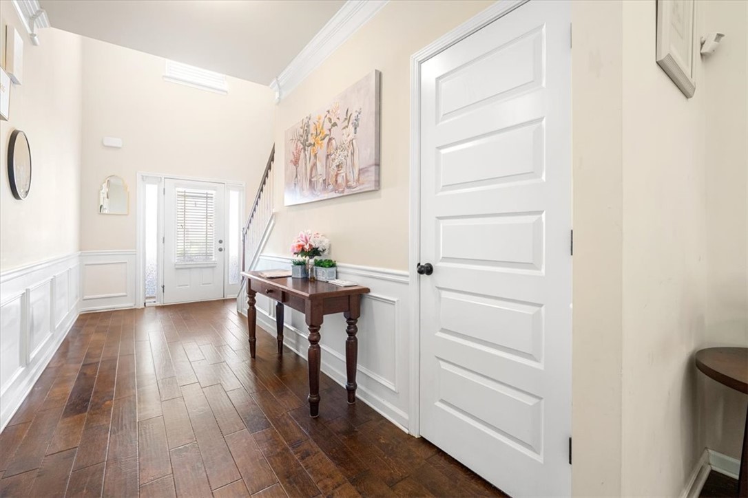 153 Border Avenue Simpsonville, SC 29680 - Photo 10 of 30 This bright entrance foyer welcomes all with timeless hardwood floors and architectural wainscoting.