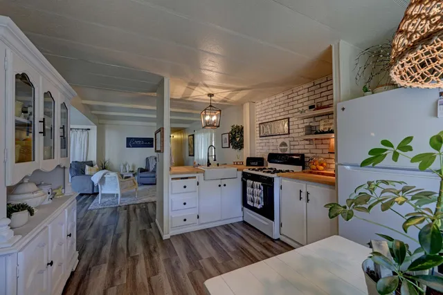 a kitchen with stainless steel appliances granite countertop a stove and cabinets