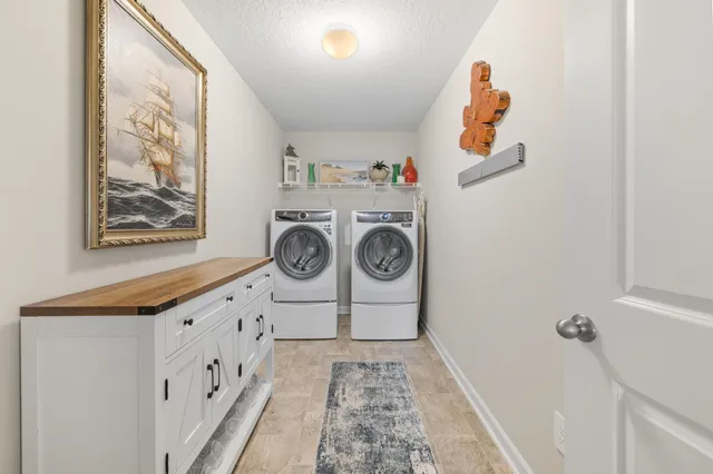 a view of a bedroom with furniture and flat screen tv