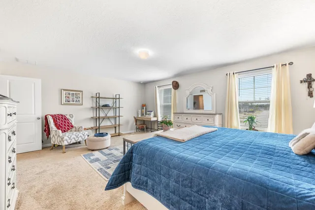 a view of a hallway with a white walls and wooden floor