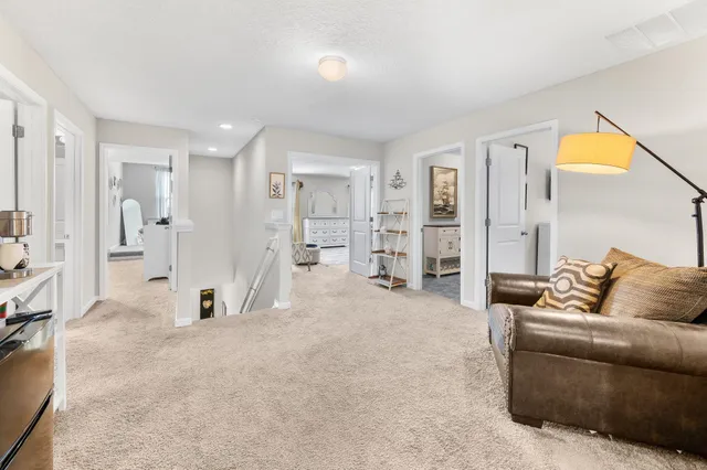 a view of an empty room with furniture and a window