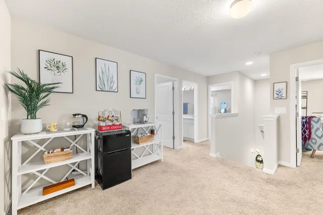 a spacious bedroom with a bed a couch and dresser