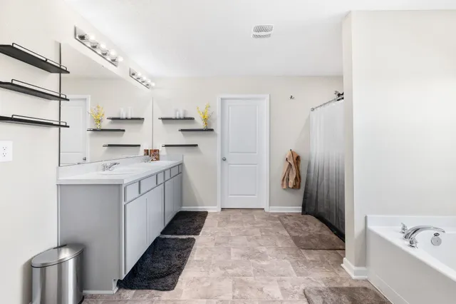 a spacious bedroom with a bed and window