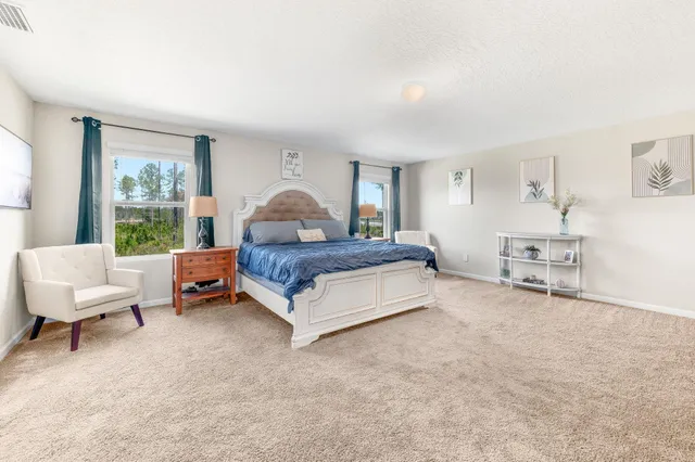 a view of swimming pool with outdoor seating and house in the background